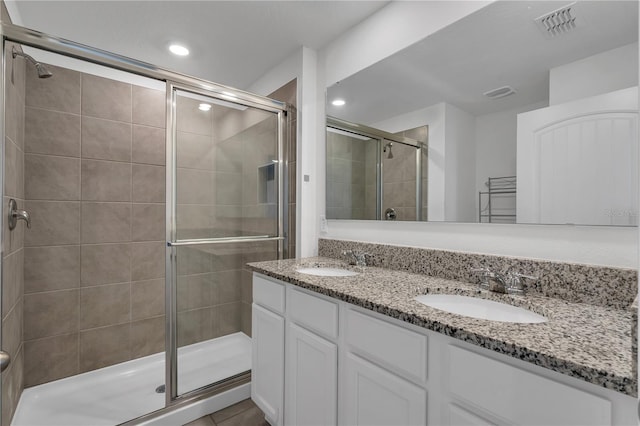 bathroom featuring vanity and a shower with shower door