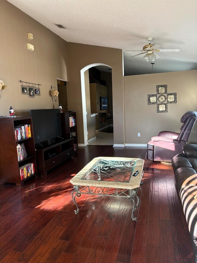 living room with hardwood / wood-style floors, vaulted ceiling, and a textured ceiling