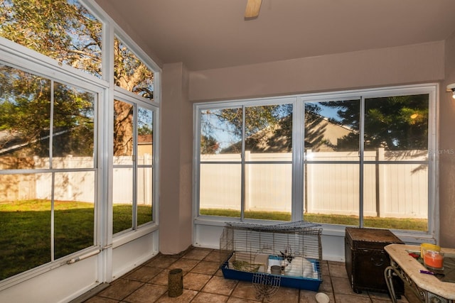 unfurnished sunroom with ceiling fan