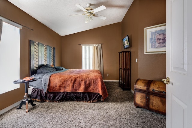 carpeted bedroom with ceiling fan, vaulted ceiling, and a textured ceiling