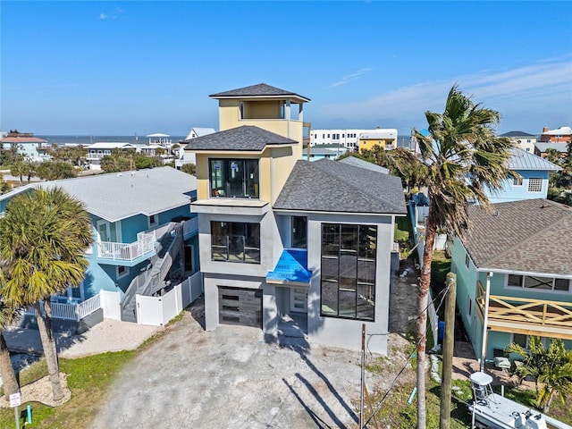 exterior space with a garage and a water view