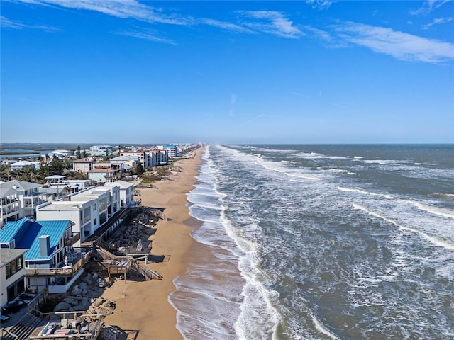 bird's eye view featuring a water view and a beach view