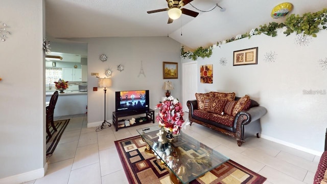 living room featuring vaulted ceiling, light tile patterned floors, and ceiling fan