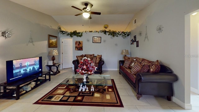 living area with light tile patterned floors, visible vents, a ceiling fan, vaulted ceiling, and baseboards