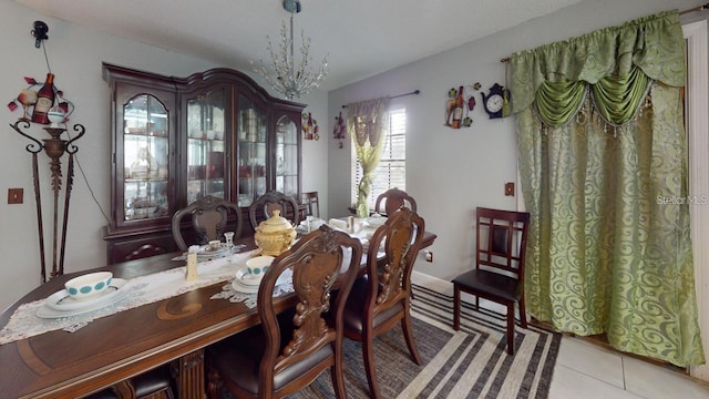 dining space with light tile patterned floors and a notable chandelier