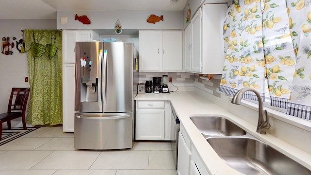 kitchen featuring light tile patterned flooring, a sink, white cabinets, light countertops, and stainless steel refrigerator with ice dispenser