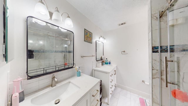 bathroom featuring two vanities, a sink, visible vents, marble finish floor, and a stall shower