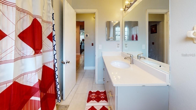 bathroom featuring vanity, baseboards, and tile patterned floors