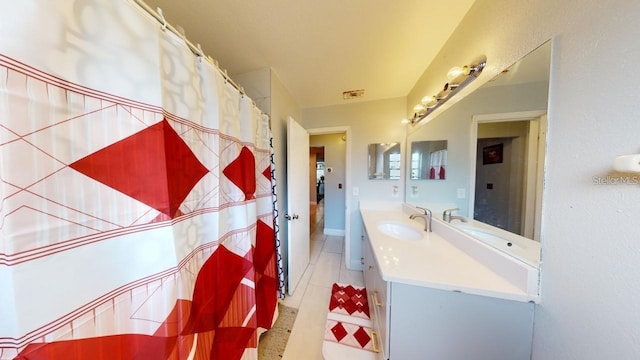 full bathroom with vanity and tile patterned floors