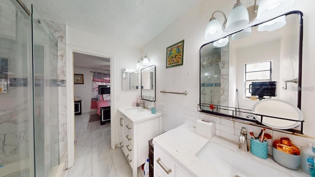 bathroom featuring vanity, an enclosed shower, and a textured ceiling