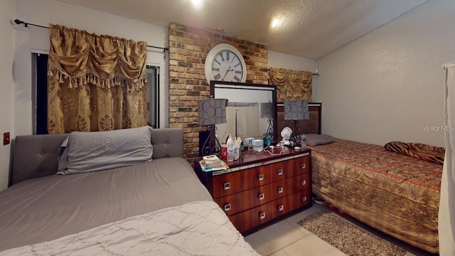 bedroom with vaulted ceiling, a textured ceiling, and light tile patterned floors