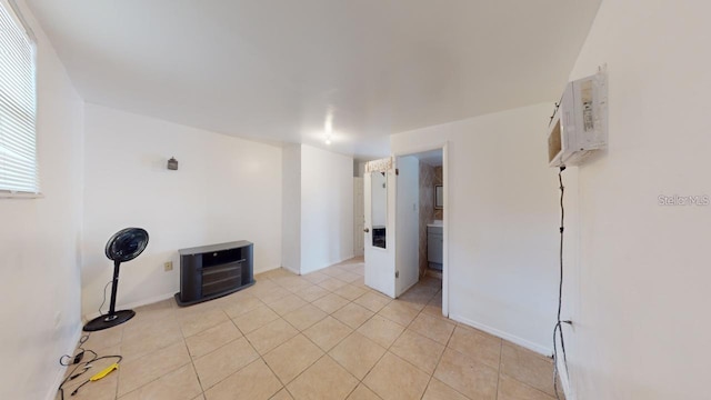 spare room with light tile patterned floors and a wall mounted AC