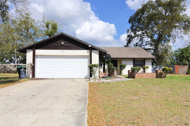 ranch-style home with a garage, fence, driveway, and a front lawn