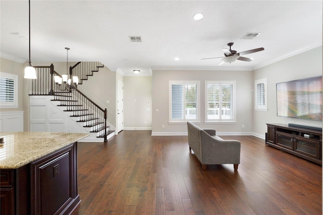 living room featuring ceiling fan, ornamental molding, and dark hardwood / wood-style floors