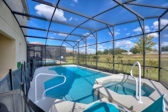 view of swimming pool with an in ground hot tub and a lanai