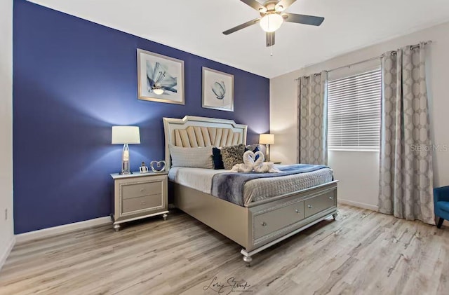 bedroom with ceiling fan and light hardwood / wood-style flooring