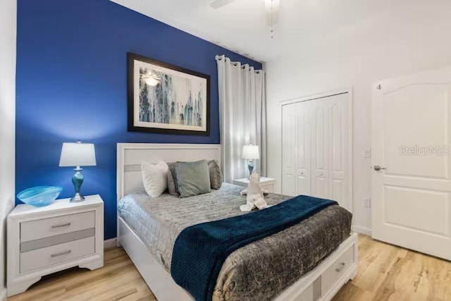 bedroom featuring ceiling fan, light hardwood / wood-style floors, and a closet