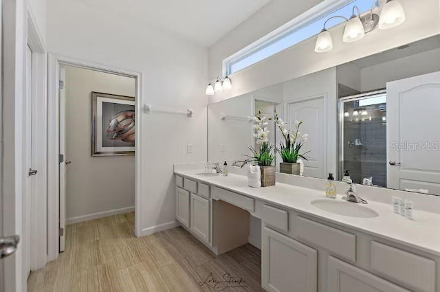 bathroom featuring vanity, wood-type flooring, and a shower with door