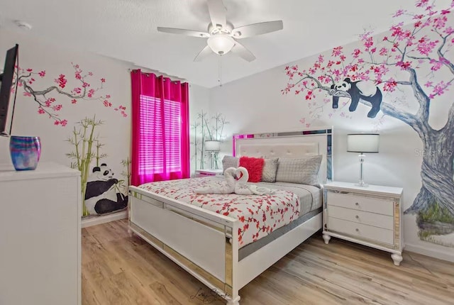 bedroom with ceiling fan and light hardwood / wood-style floors