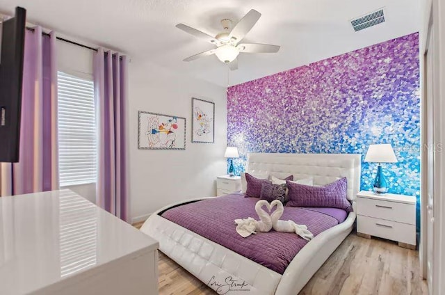 bedroom featuring ceiling fan and light hardwood / wood-style floors