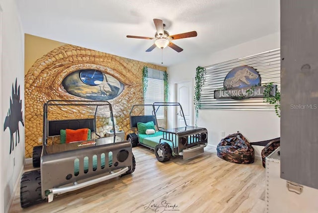 bedroom featuring hardwood / wood-style flooring and ceiling fan