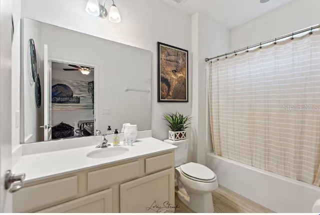 full bathroom with vanity, shower / bath combination with curtain, ceiling fan, and toilet