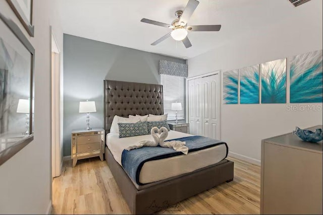 bedroom with a closet, ceiling fan, and light hardwood / wood-style flooring