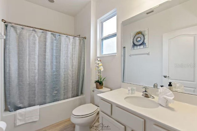 full bathroom featuring vanity, shower / tub combo, hardwood / wood-style floors, and toilet