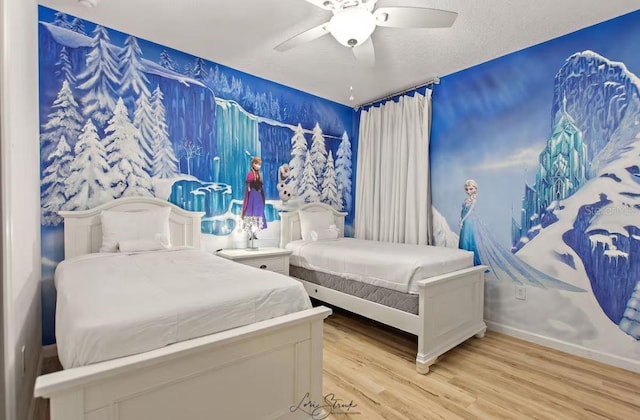 bedroom featuring a textured ceiling, ceiling fan, and light wood-type flooring