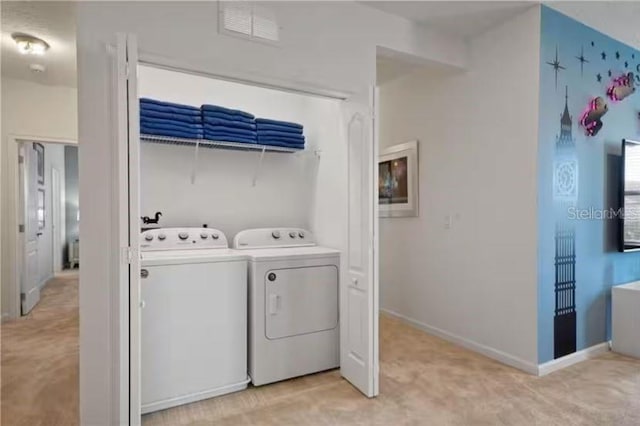 washroom with washing machine and clothes dryer