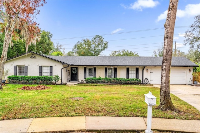 ranch-style home featuring a garage and a front lawn