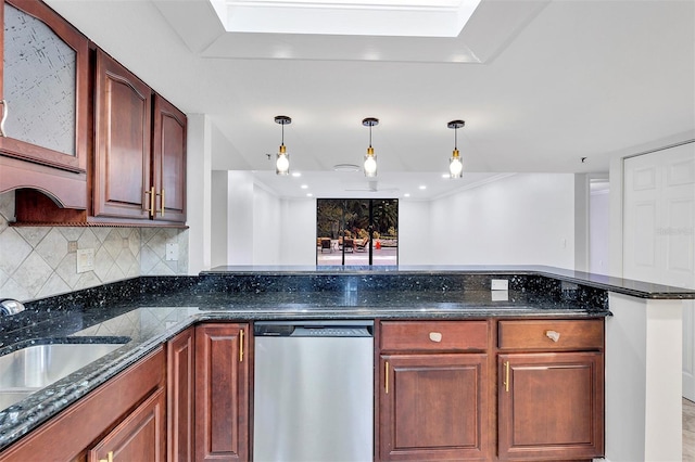 kitchen featuring pendant lighting, dishwasher, sink, and dark stone countertops