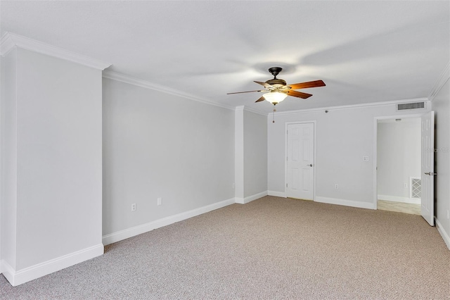 carpeted spare room with ornamental molding and ceiling fan