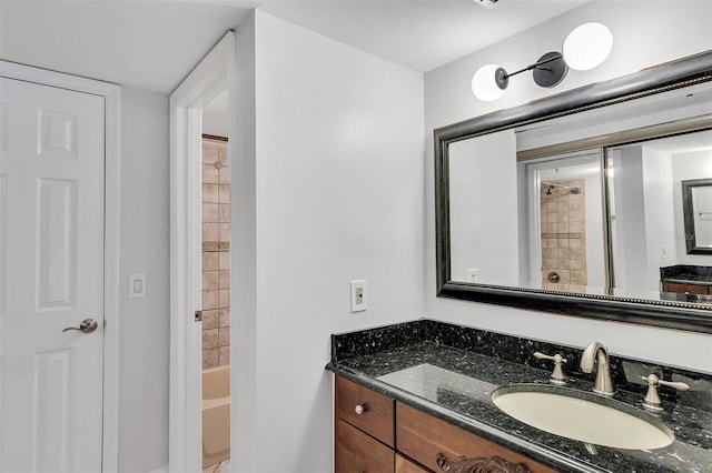 bathroom featuring vanity and tiled shower / bath combo