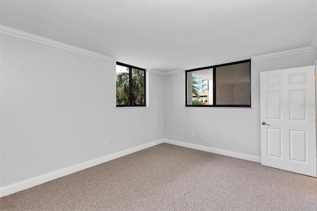 carpeted spare room with crown molding