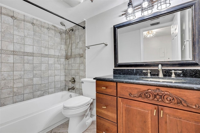 full bathroom with vanity, tiled shower / bath, tile patterned floors, and toilet