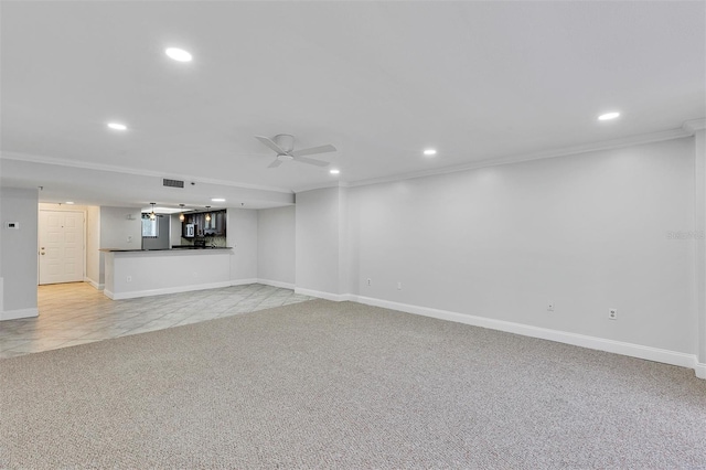 basement featuring crown molding, light colored carpet, and ceiling fan