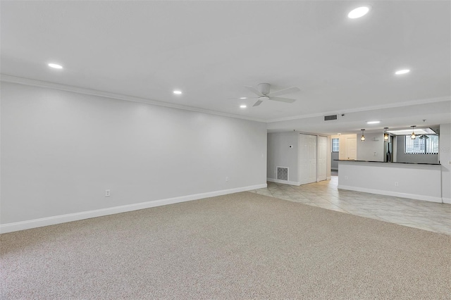 unfurnished living room featuring crown molding, ceiling fan, and light carpet