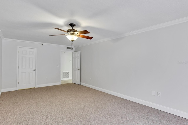 empty room with ceiling fan, ornamental molding, and carpet