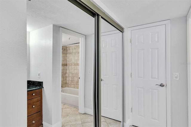 bathroom with tile patterned floors, vanity, and bathing tub / shower combination