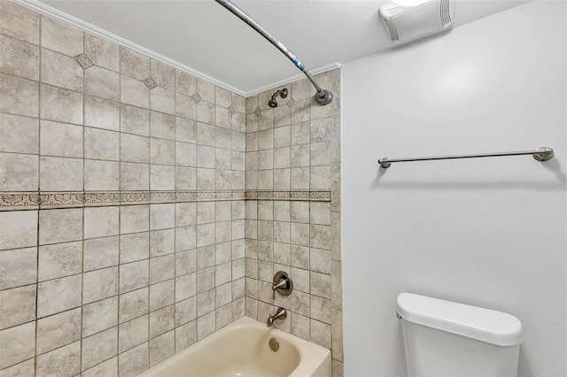 bathroom with tiled shower / bath combo and toilet