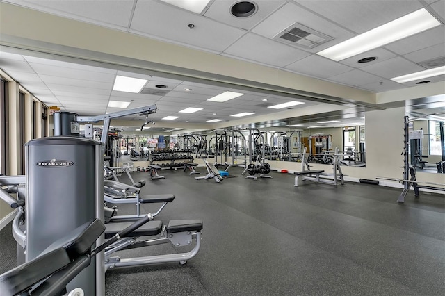 gym with a paneled ceiling