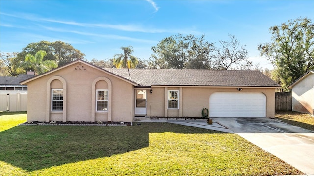 single story home with a garage and a front lawn