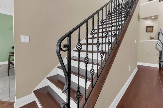 staircase featuring wood-type flooring