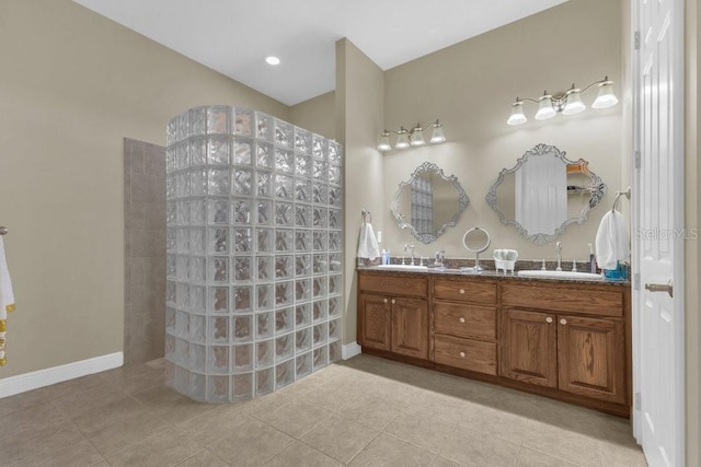 bathroom featuring tile patterned flooring, vanity, and walk in shower