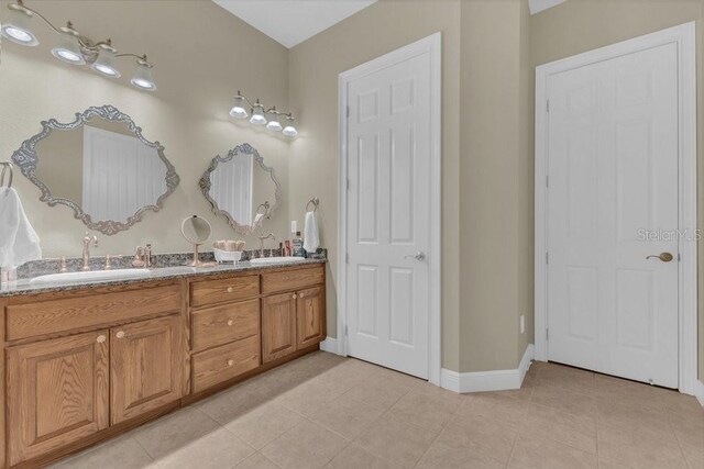 bathroom with tile patterned flooring and vanity