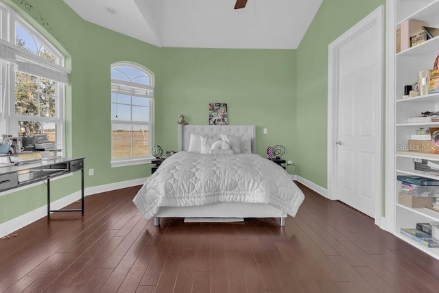 bedroom with lofted ceiling, dark wood-type flooring, and ceiling fan