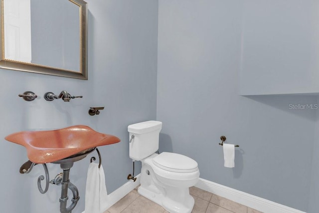 bathroom featuring toilet and tile patterned flooring