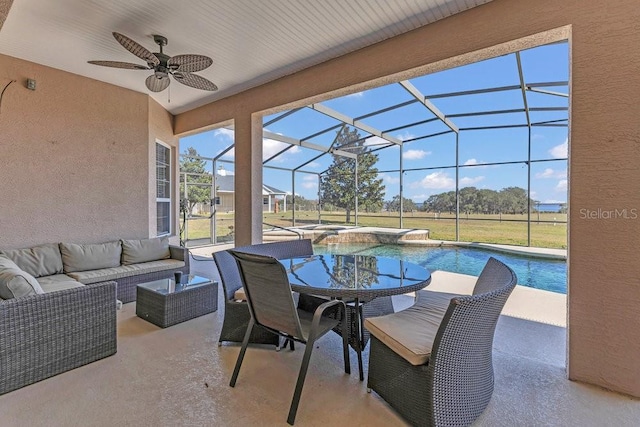 view of patio / terrace with ceiling fan, an outdoor living space, and a lanai