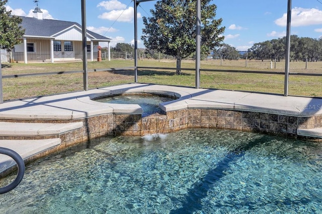 view of swimming pool featuring an in ground hot tub and a lawn